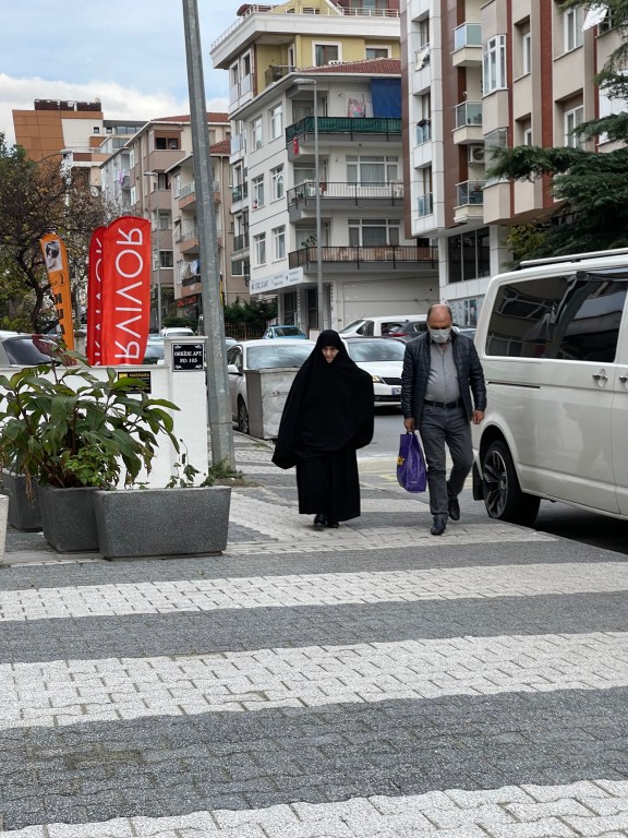 woman cloaked in all black